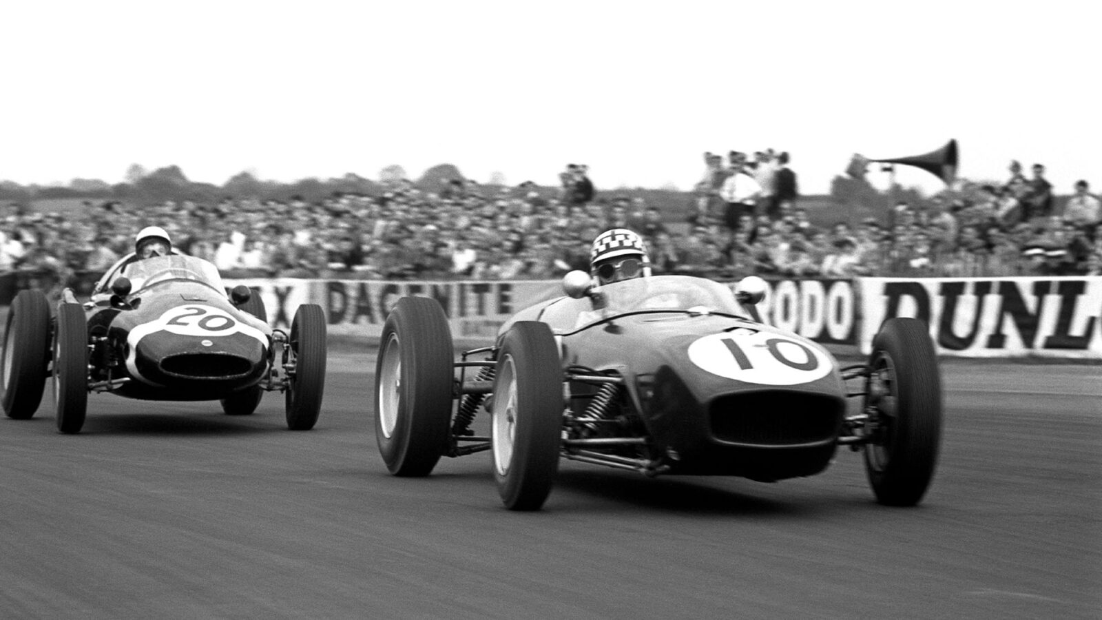 Innes Ireland in a Lotus 18 leads Stirling Moss in a Walker Cooper T51 Climax in the XII BRDC Daily Express International Trophy. Silverstone, England 14 May 1960. (Photo by: GP Library/Universal Images Group via Getty Images)