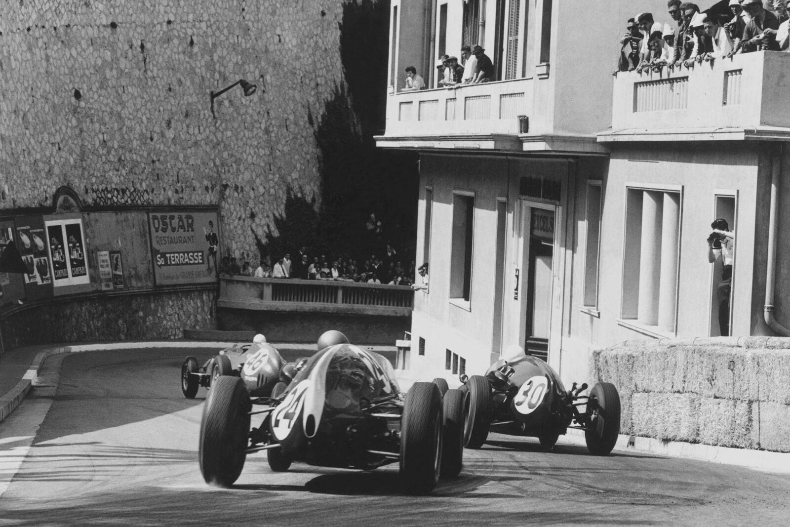 Jean Behra in a Ferrari Dino 246 leads Stirling Moss in his Cooper T51-Climax