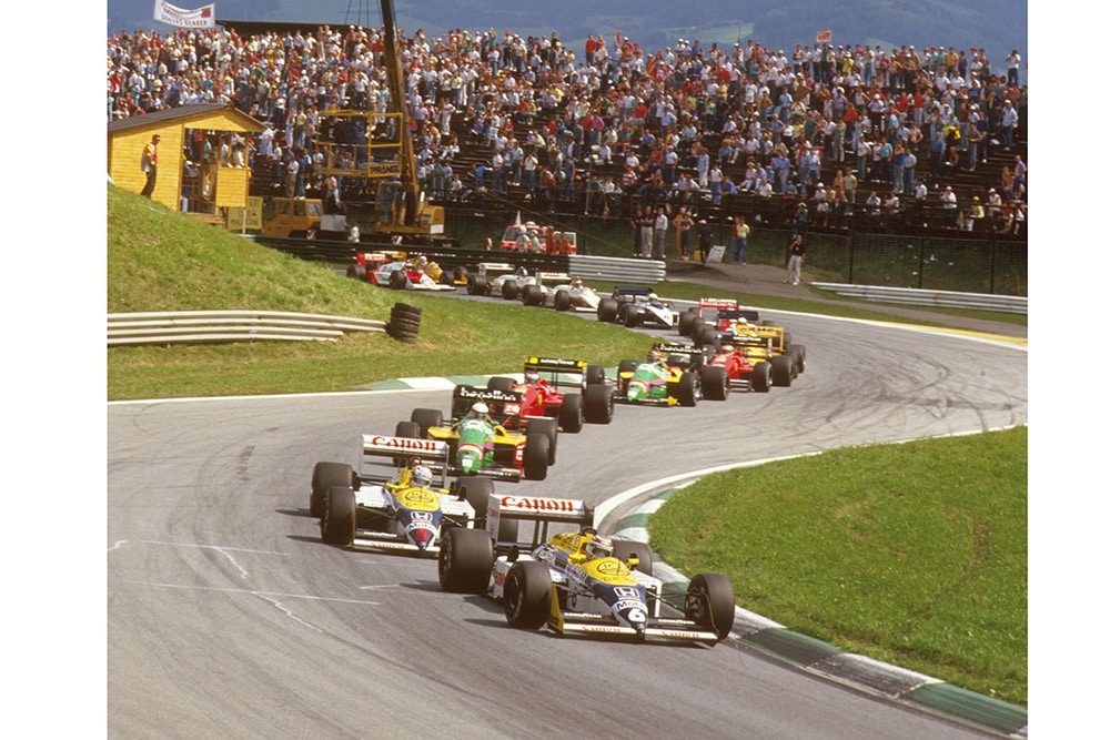 Nelson Piquet leads teammate Nigel Mansell (both Williams FW11B Honda's), Teo Fabi (Benetton B187 Ford) and Gerhard Berger (Ferrari F187) at the start.
