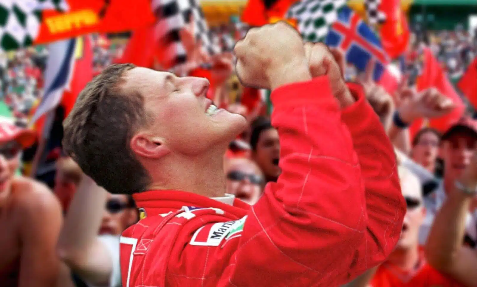Michael Schumacher looks to the sky in celebration after winning 2000 F1 world championship