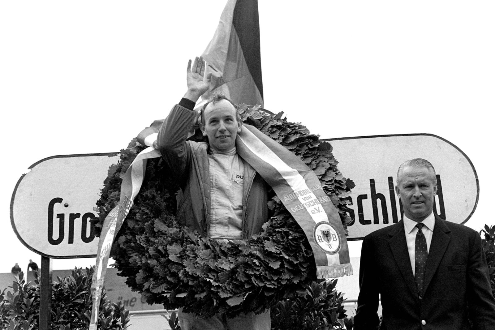 John Surtees on the podium after winning the 1964 German Grand Prix for Ferrari