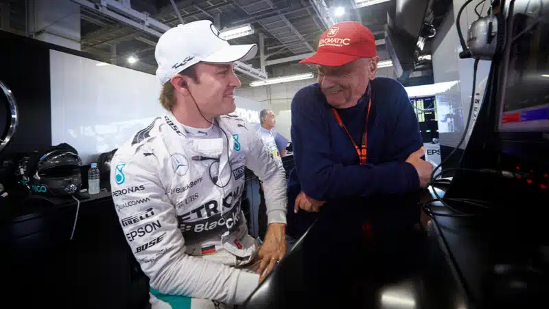 Niki Lauda talks with Nico Rosberg in Mercedes F1 pit garage