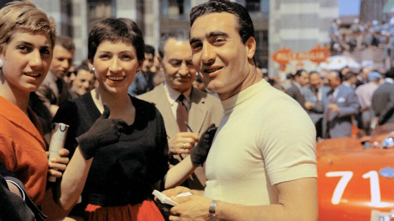 Eugenio Castellotti signs autographs ahead of the 1955 Mille Miglia
