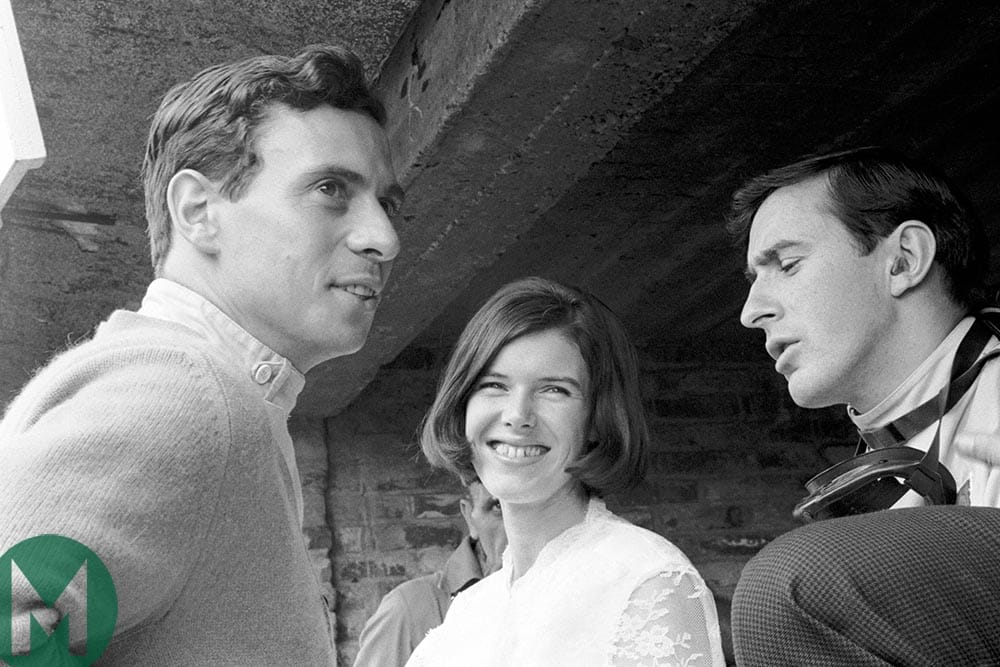 Jackie Stewart talks to Jim clark with Colin Chapman in the background at the 1953 French Grand Prix at Reims