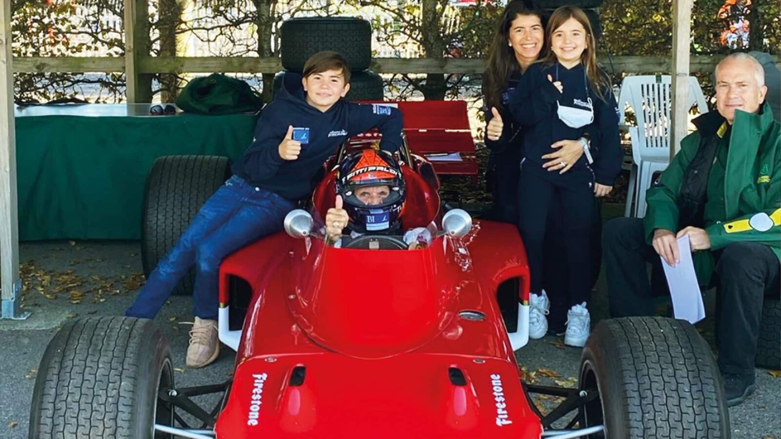 Emerson Fittipaldi gives the thumbs up sitting in his championship-winning Lotus 72