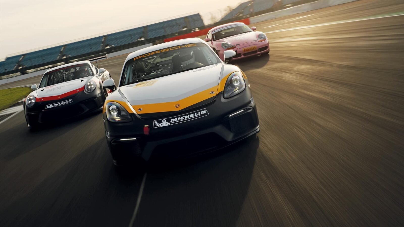 Porsche 986 Boxster S, Cayman GT4 and 911 Gt3 Cup on track at SIlverstone - front