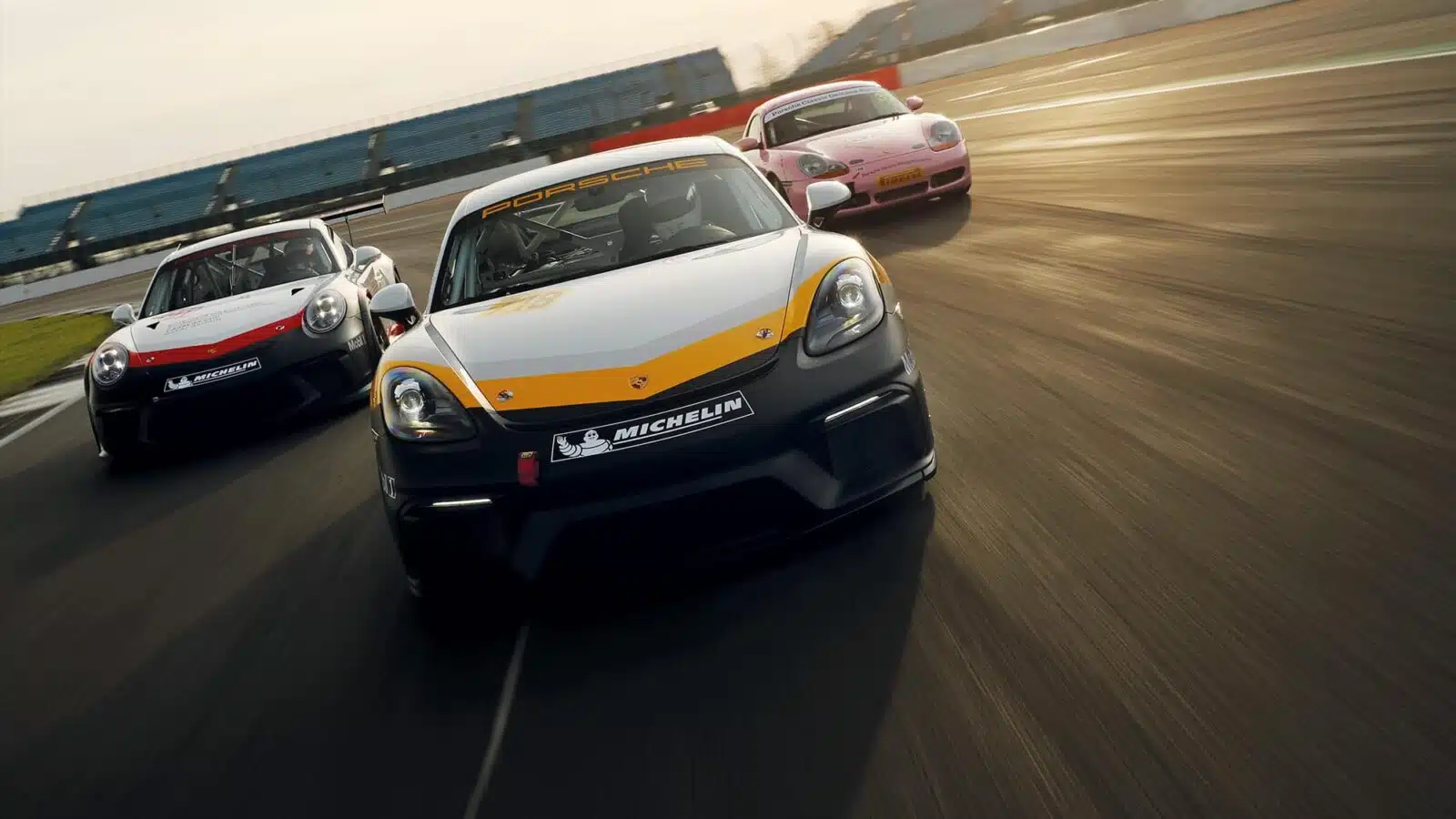 Porsche 986 Boxster S, Cayman GT4 and 911 Gt3 Cup on track at SIlverstone - front