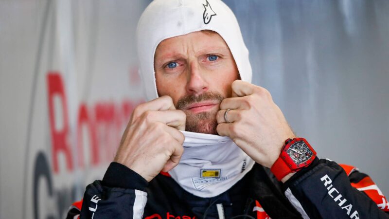 Romain Grosjean puts on a balaclava before racing for Hass