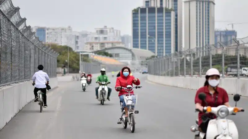 Moped and bicycle riders travel on the Hanoi Street Circuit in Vietnam