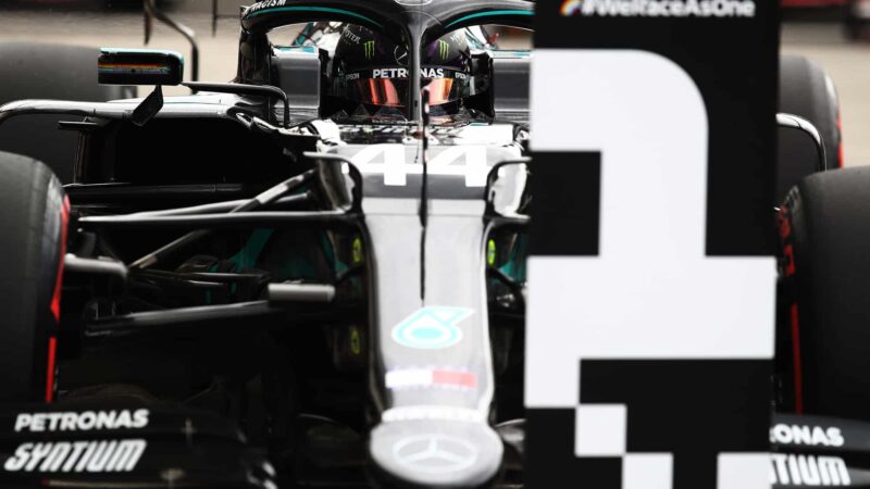 Lewis Hamilton next to a number 1 board