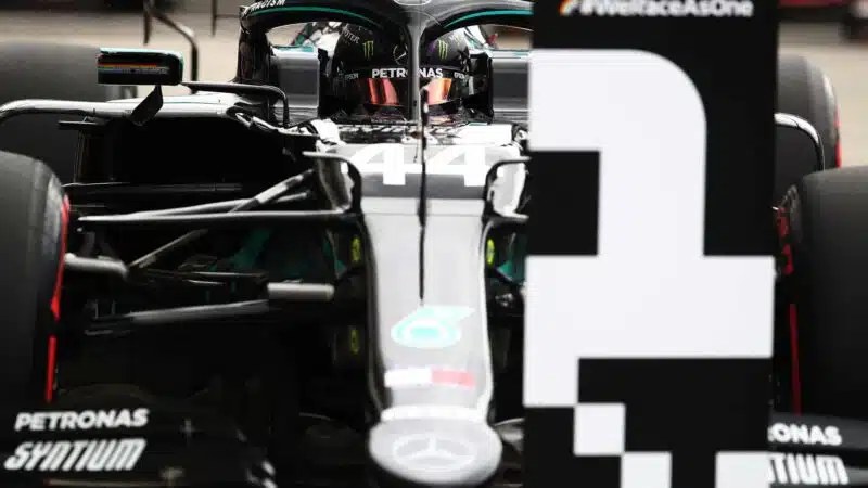Lewis Hamilton next to a number 1 board