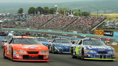 WATKINS GLEN, NY - AUGUST 14: Tony Stewart, driver of the #20 Home Depot Chevrolet, and other drivers gather before the start of the NASCAR Nextel Cup Series Sirius Satellite Radio at the Glen on August 14, 2005 at the Watkins Glen International Raceway in Watkins Glen, New York. (Photo By Streeter Lecka/Getty Images)