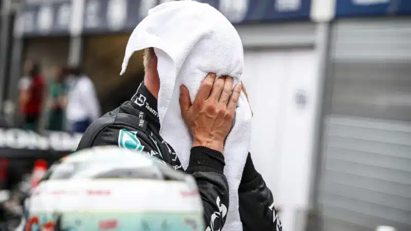 Valtteri Bottas with his face in a towel after 2021 Monaco GP qualifying