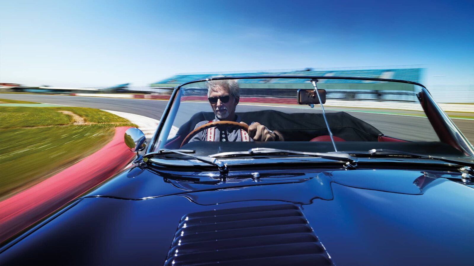 Bonnet shot of Damon Hill in Graham Hill race-winning Jaguar E-type