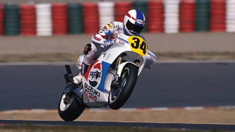 Kevin Schwantz lifts the front wheel of his Suzuki at Suzuka 1988