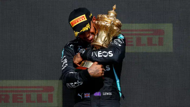 Lewis Hamilton holds the trophy after he wins the 2021 British Grand Prix
