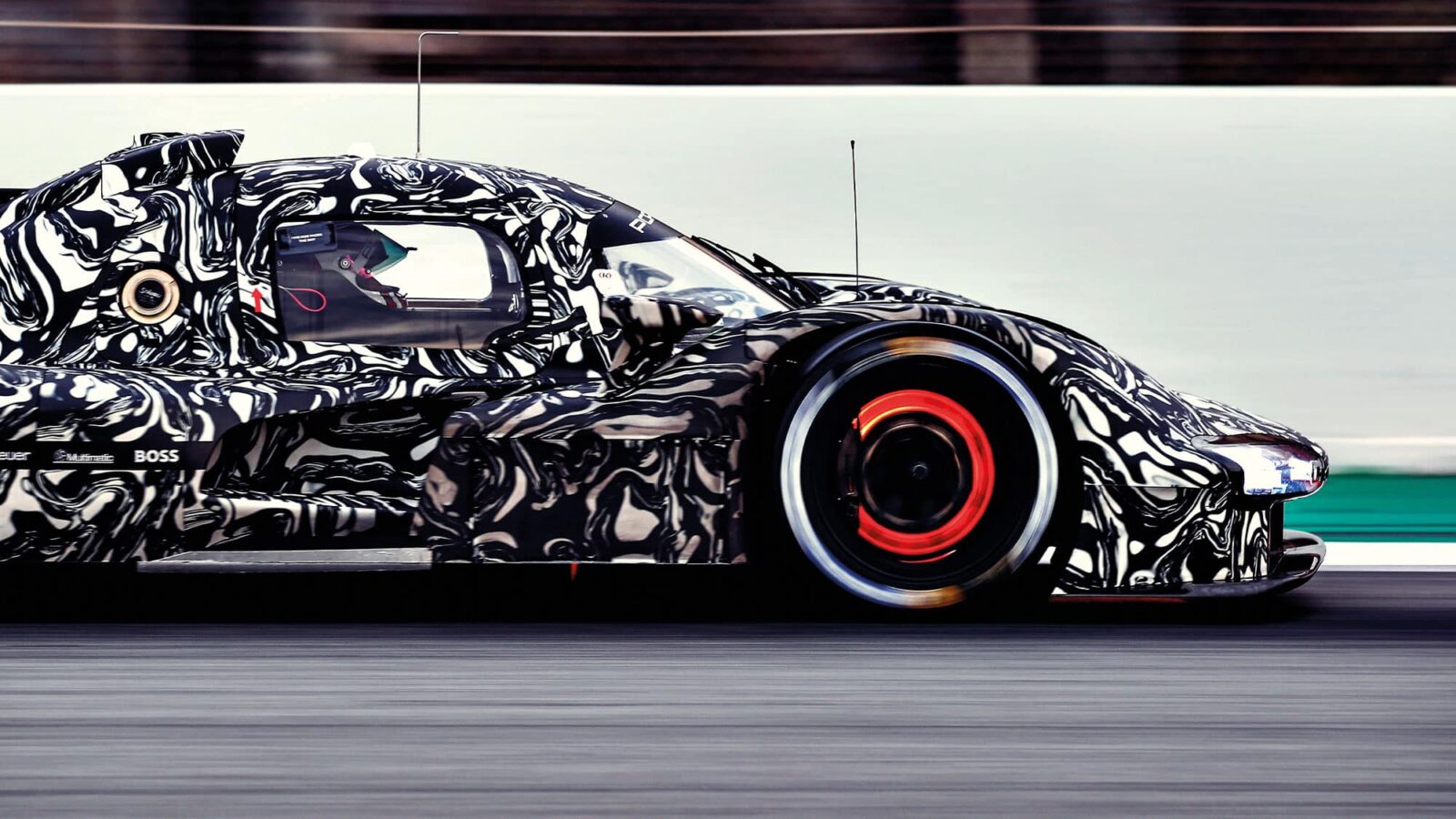 Porsche LMDh car side-on shot