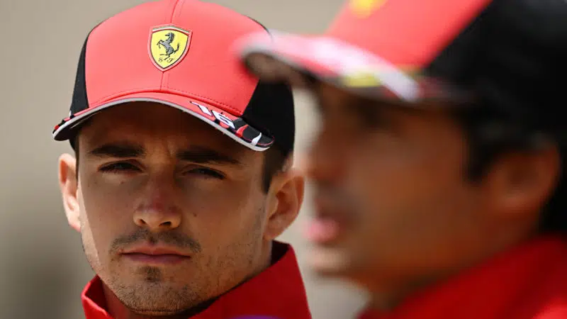Charles Leclerc next to an out of focus Carlos Sainz