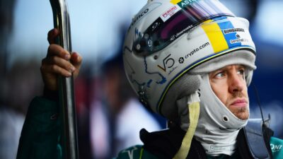 Sebastian Vettel in the Albert PArk pits with helmet sitting on the top of his head