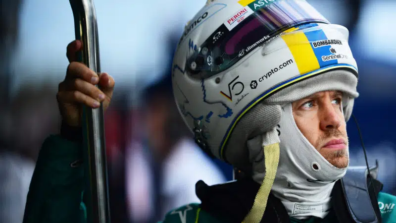 Sebastian Vettel in the Albert PArk pits with helmet sitting on the top of his head