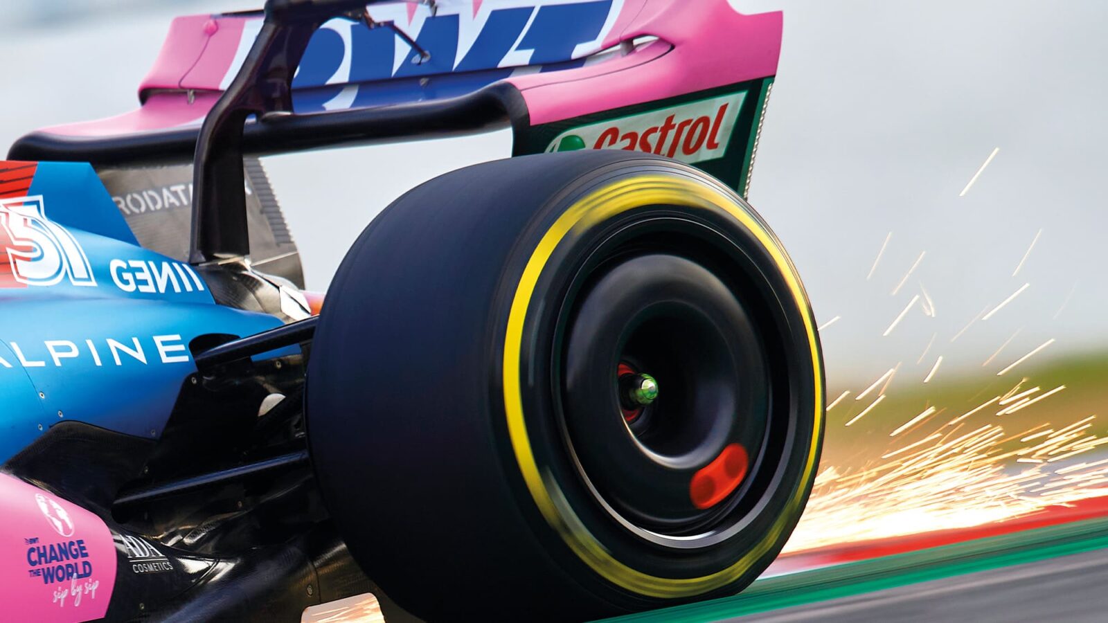 Sparks fly from the rear of an Alpine F1 car