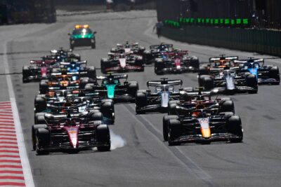 Charles Leclerc (Ferrari) brakes hard with smoke from his tyres as Max Verstappen (Red Bull-Honda) takes the least at the start of the 2022 Azerbaijan Grand Prix in Baku. Photo: Grand Prix Photo