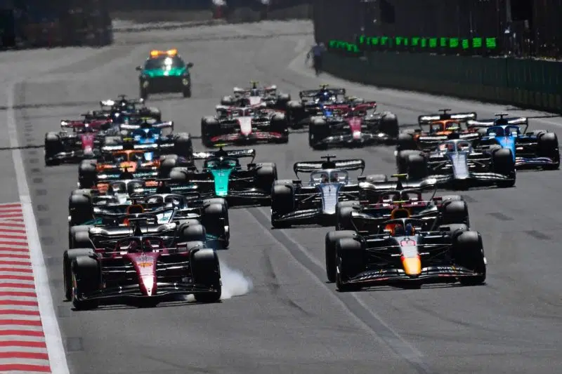 Charles Leclerc (Ferrari) brakes hard with smoke from his tyres as Max Verstappen (Red Bull-Honda) takes the least at the start of the 2022 Azerbaijan Grand Prix in Baku. Photo: Grand Prix Photo