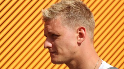 Mick Schumacher against an orange background