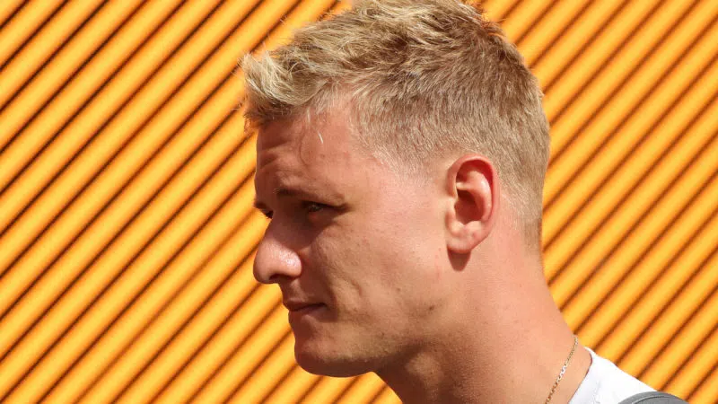 Mick Schumacher against an orange background