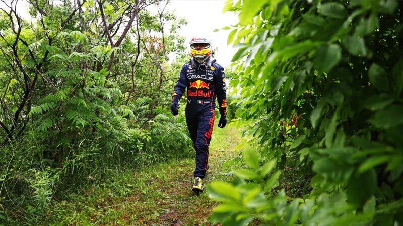 Sergio Perez walks along a leafy path alongside the Circuit Gilles Villeneuve