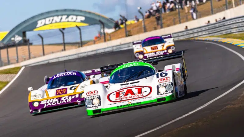 Group-C-cars-in-front-of-Dunlop-Bridge-in-the-2022-Le-Mans-Classic