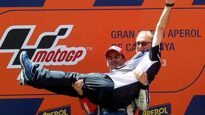 Jorge Lorenzo carries ramon Forcada on the podium after the 2013 MotoGP Catalan GP