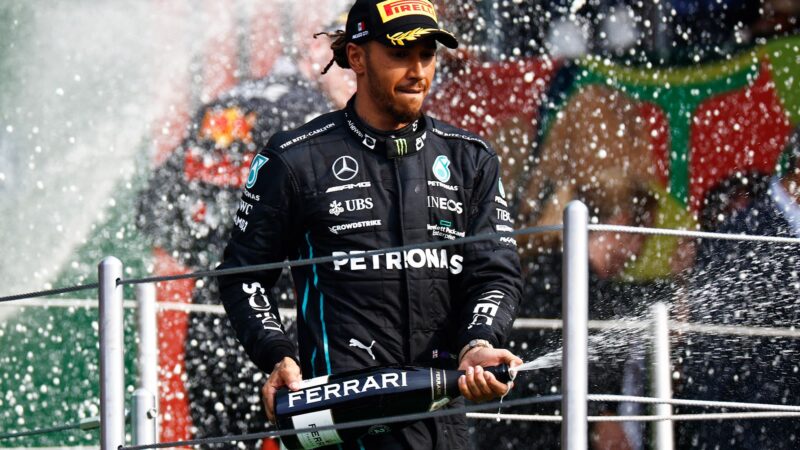 Lewis Hamilton sprays champagne on the podium after the 2022 Mexican Grand Prix