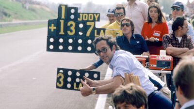 Mauro-Forghieri-raises-his-thumbs-as-he-leans-over-pitwall