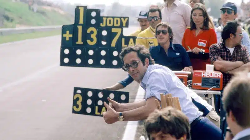 Mauro-Forghieri-raises-his-thumbs-as-he-leans-over-pitwall
