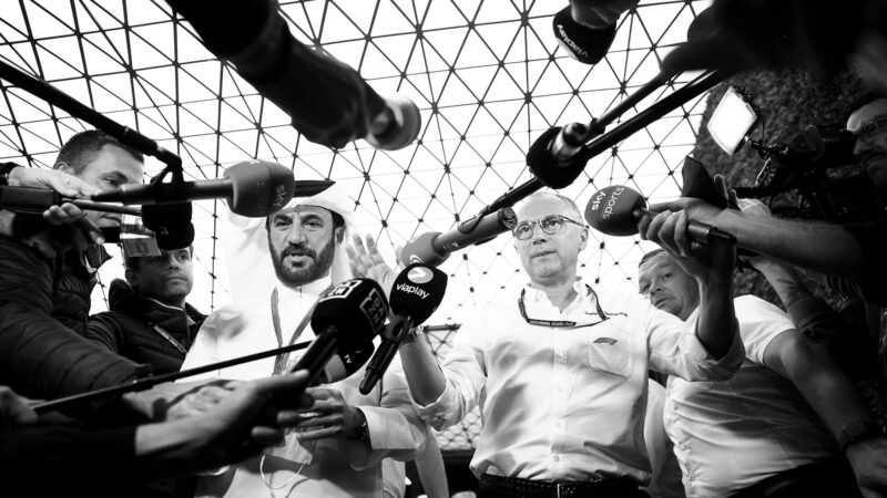 Mohammed Ben Sulayem and Stefano Domenicali speak in front of a line of microphones