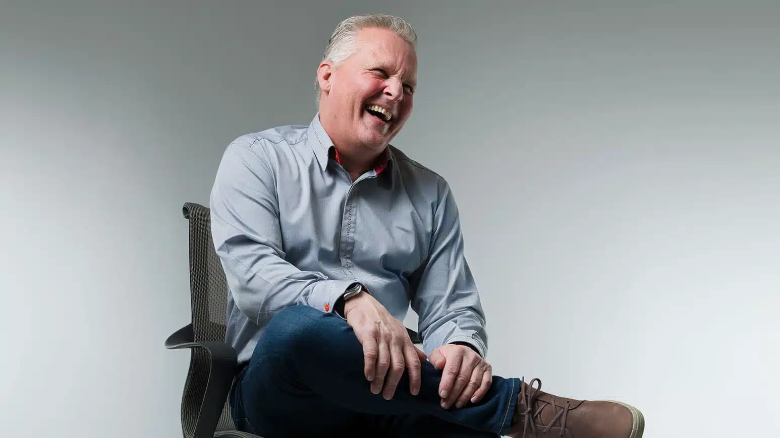 Johnny Herbert sitting and laughing