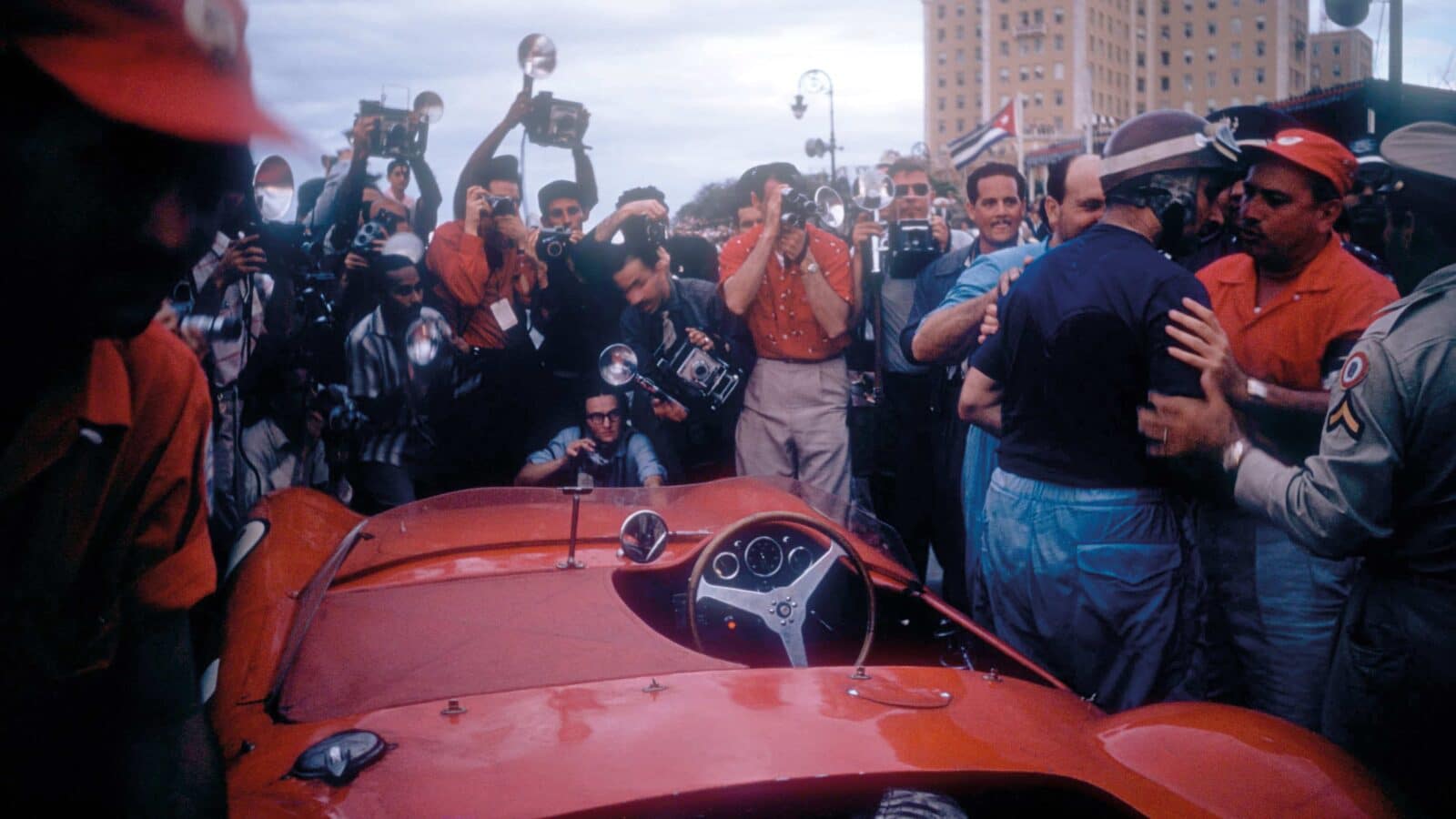 Juan Manuel Fangio climbsout of his Maserati