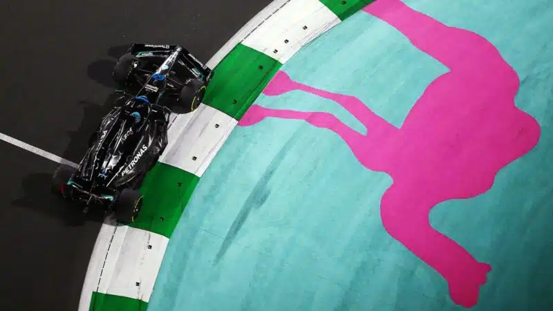 George Russell races past the outline of a camel on Jeddah street circuit at the 2023 Saudi Arabian Grand Prix