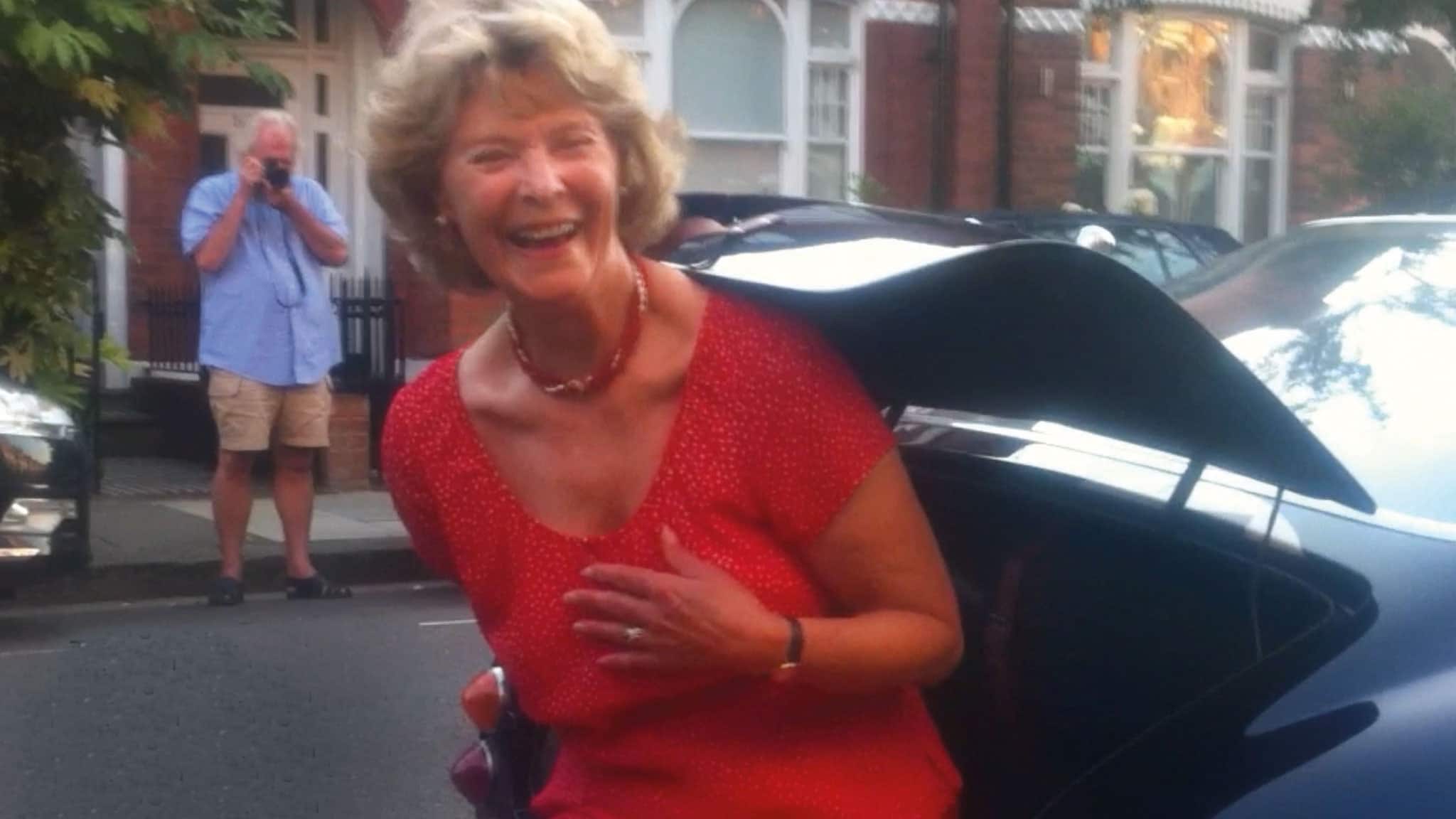 Lady cimbling out of the boot