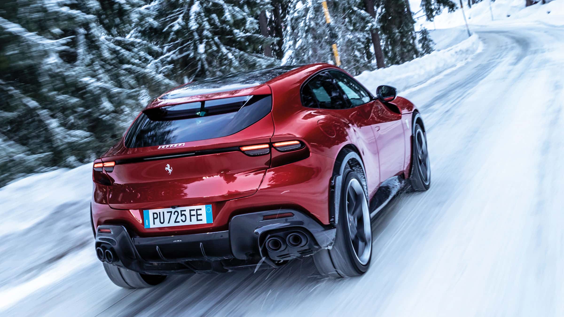 Rear of Ferrari Purosangue driving in the snow