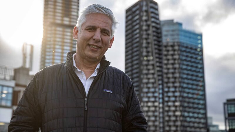 Robin Tulule in front of skyscrapers