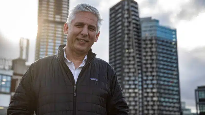 Robin Tulule in front of skyscrapers