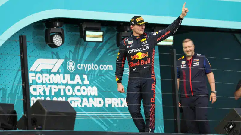 Max-Verstappen-raises-finger-on-podium-after-winning-2023-F1-Miami-GP