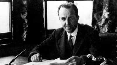 Cecil Kimber sits at desk