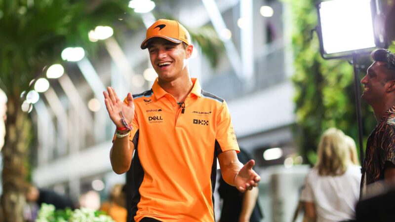 Lando Norris claps his hands in 2023 Singapore GP paddock