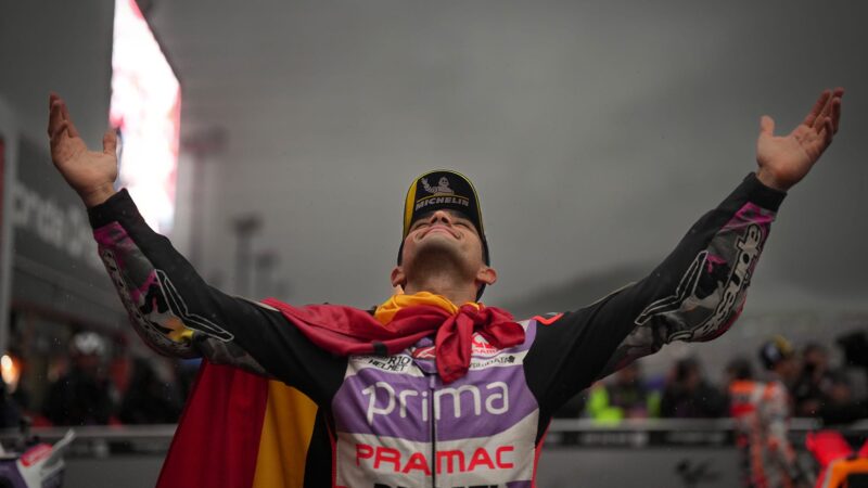 Jorge Martin raises his arms while wearing the Spanish flag after winning 2023 MotoGP Japanese Grand Prix