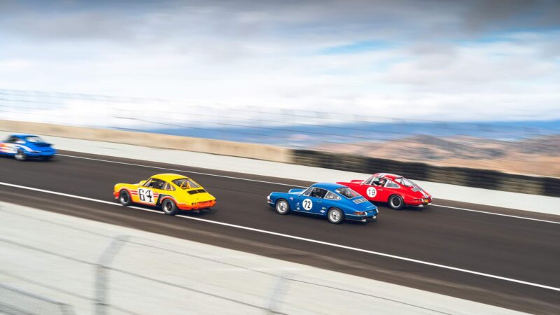 Porsche 911s climbing Laguna Seca hill at 2023 Rennsport Reunion
