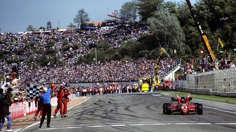 Patrick Tambay raises his hands in the air as he crosses the line to win the 1983 San Marino Grand Prix