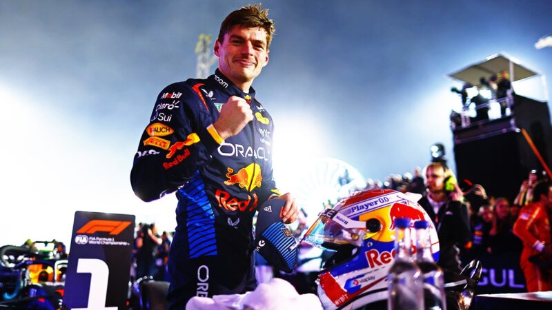 Max Verstappen pumps his fist in front of number 1 board after winning 2024 Bahrain GP